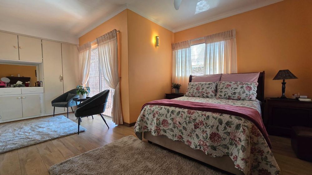 Main bedroom with laminated floors and small pajama area