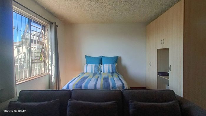 Gqeberha Central Apartment For Sale: Secure complex, prepaid utilities, spacious bachelor unit.