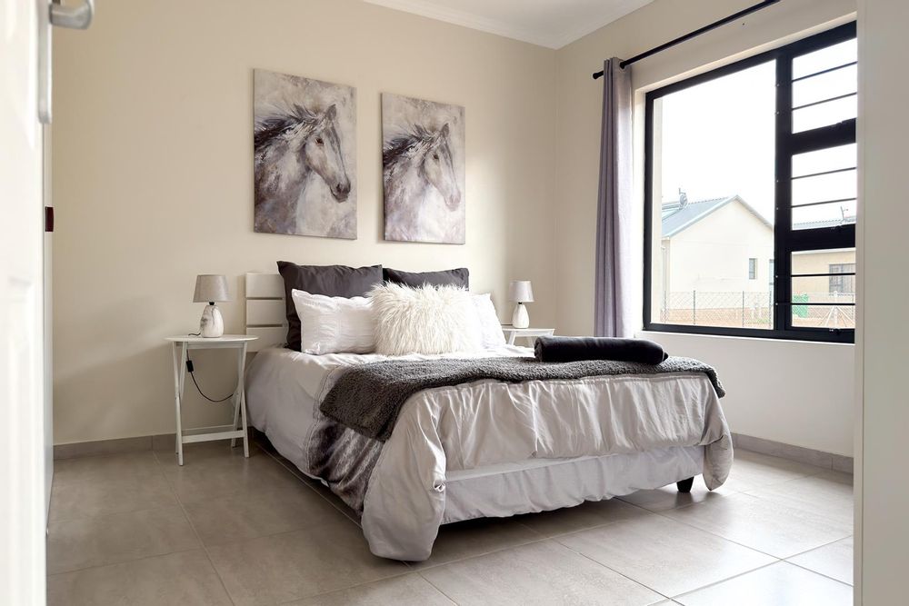 Main bedroom with built-in cupboards and ensuite bathroom.