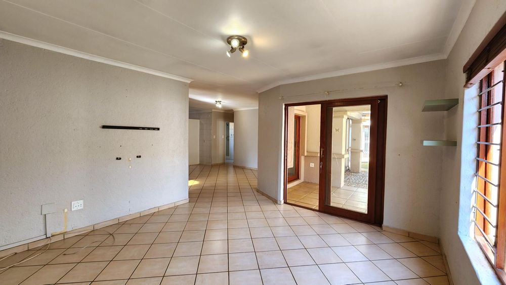 Lounge with sliding door opening onto entertainment patio.