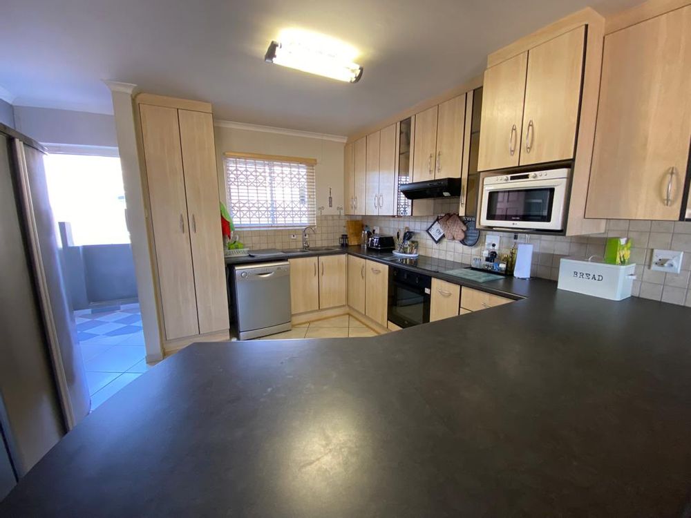 Open-plan kitchen with BIC and front door entrance