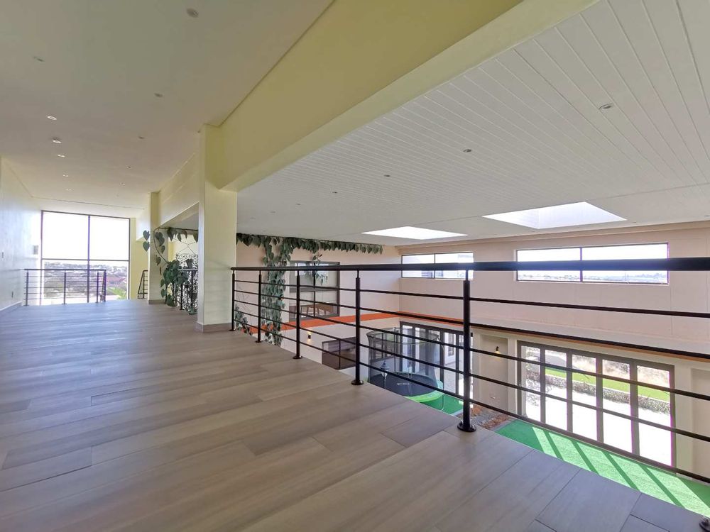 TOP FLOOR LOOKING DOWN TO THE INDOOR GARDEN WITH POOL