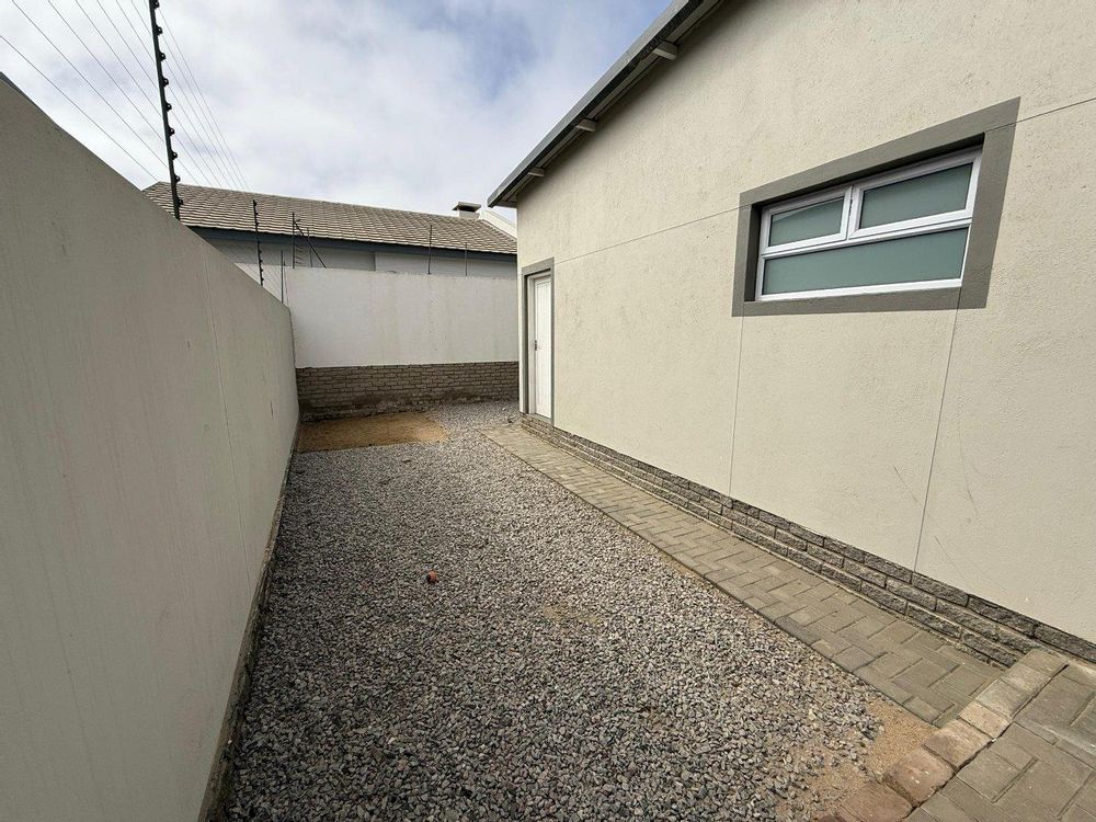 External walkway leading to a separate toilet and washbasin