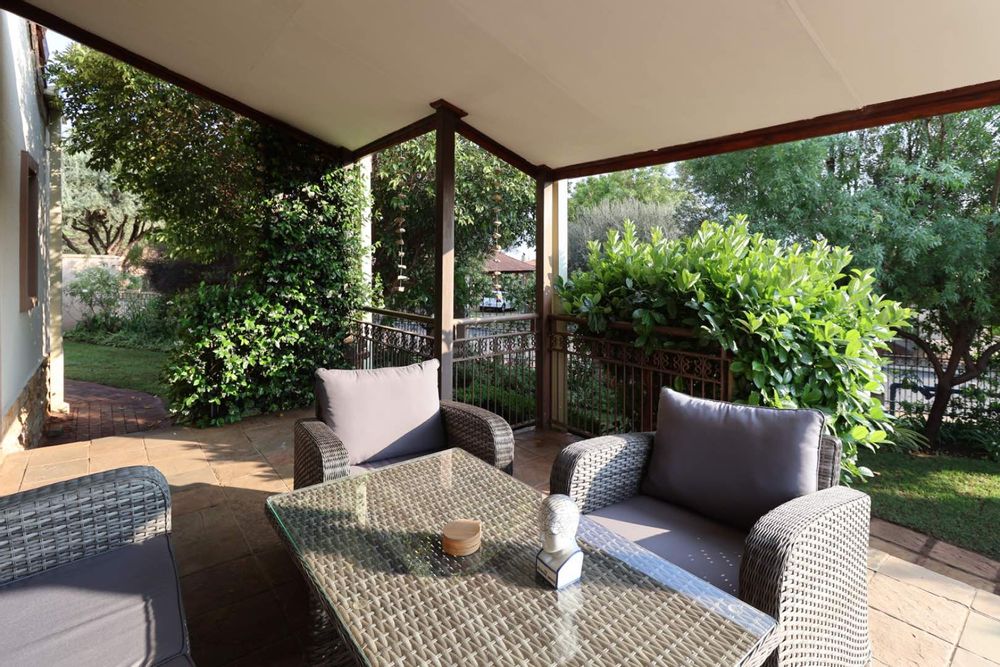 Patio enveloped by lush garden