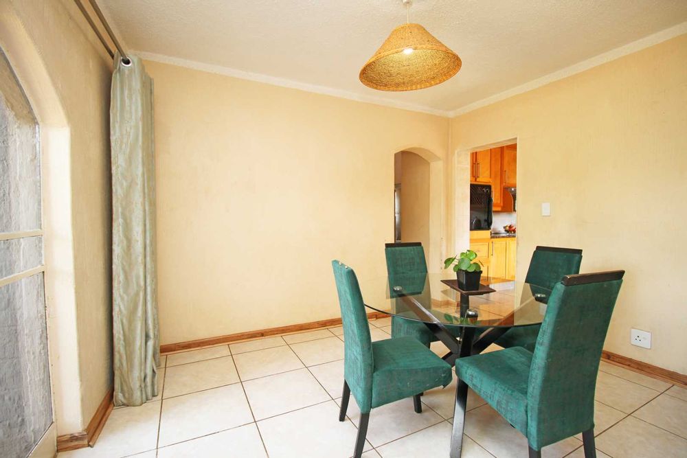 Dining Room with tiled floors and glass doors that connects the home with the lovely swimming pool, entertainment area and Garden Terrace.  The Kitchen, Scullery and Dining Room is conveniently placed in close proximity.