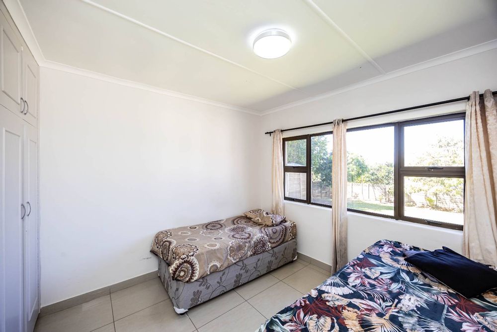 Bedroom 3 with views of the backyard