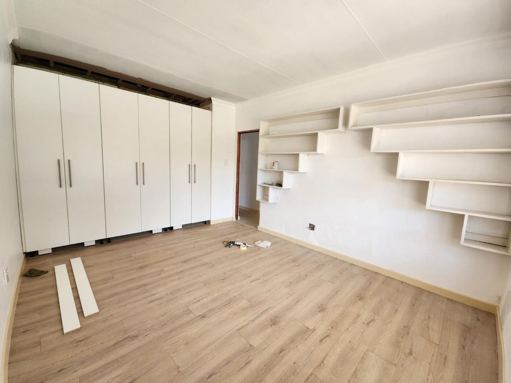 Main bedroom with new floors and wardrobe going in