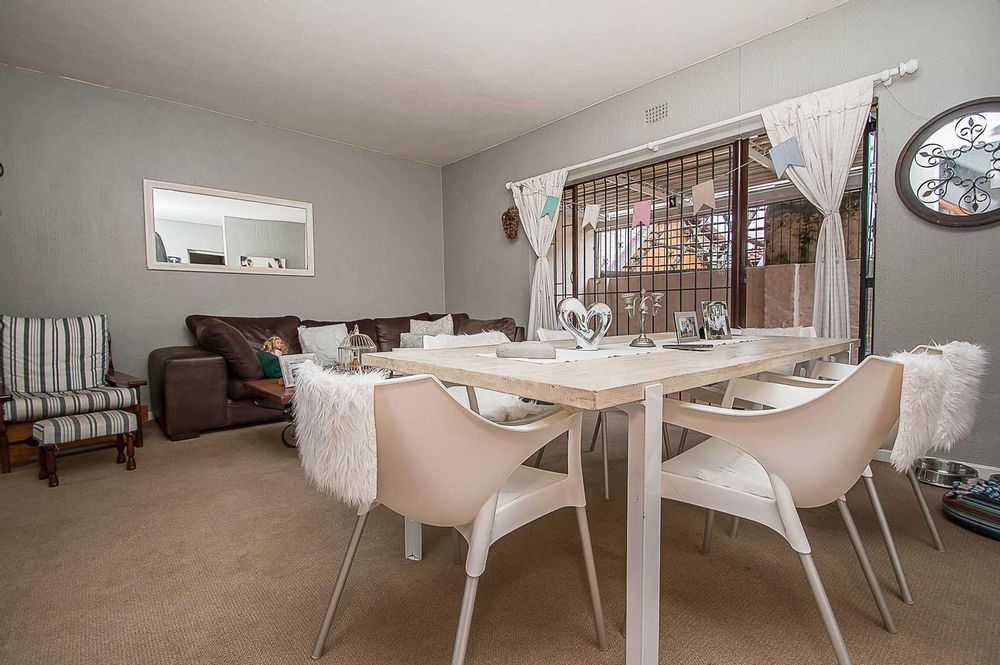 Dining room area with enclosed patio in background