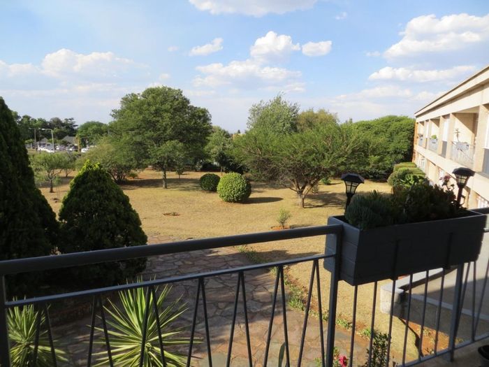 Spacious 3-bedroom apartment with balcony, garage, and open parking in Monument. For Sale.