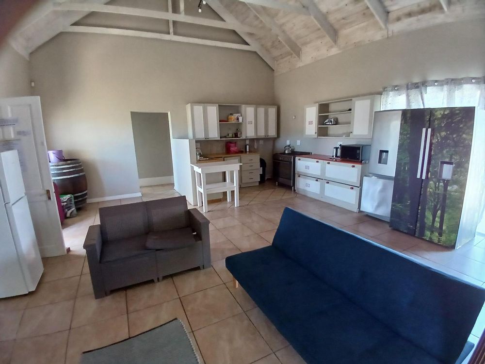 Half of the spacious Living Area - with Kitchen at the back. Front door on our left and access to our 3 Bedrooms at the back.