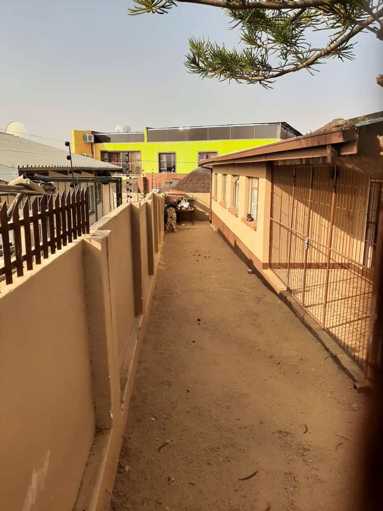 Backyard with enclosed patio on the right.