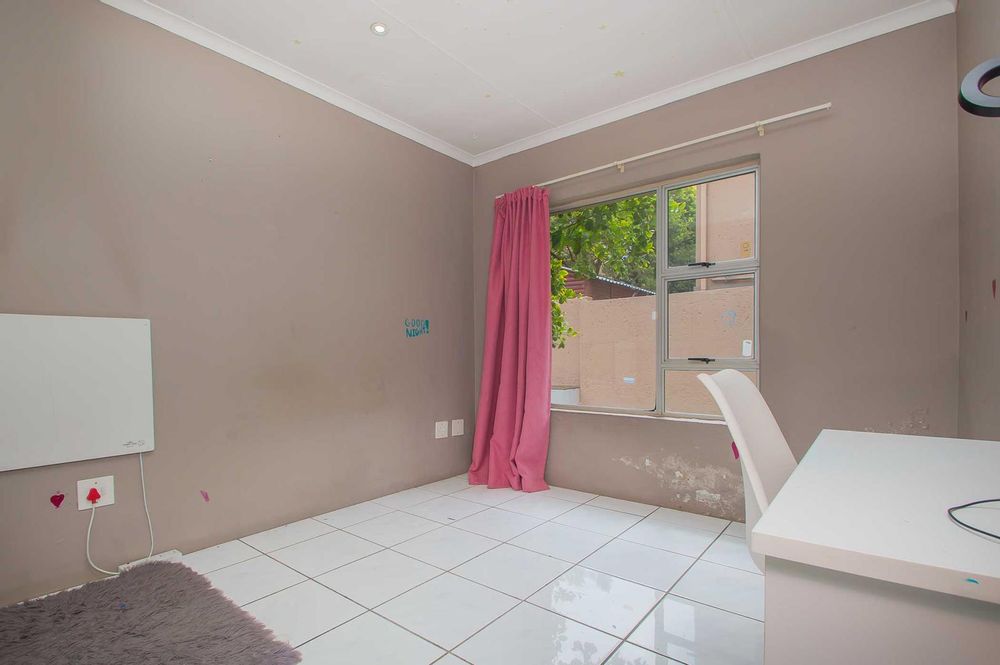 spcious and sunny 3rd bedroom looks out to garden an pool 