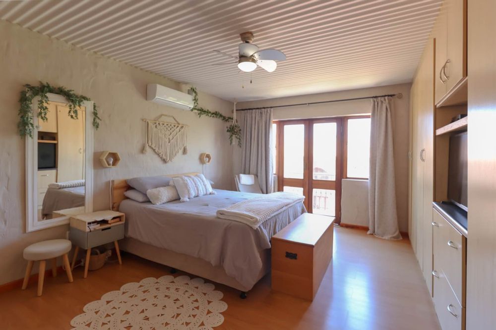 Main bedroom with built-in cupboards and air-conditioner