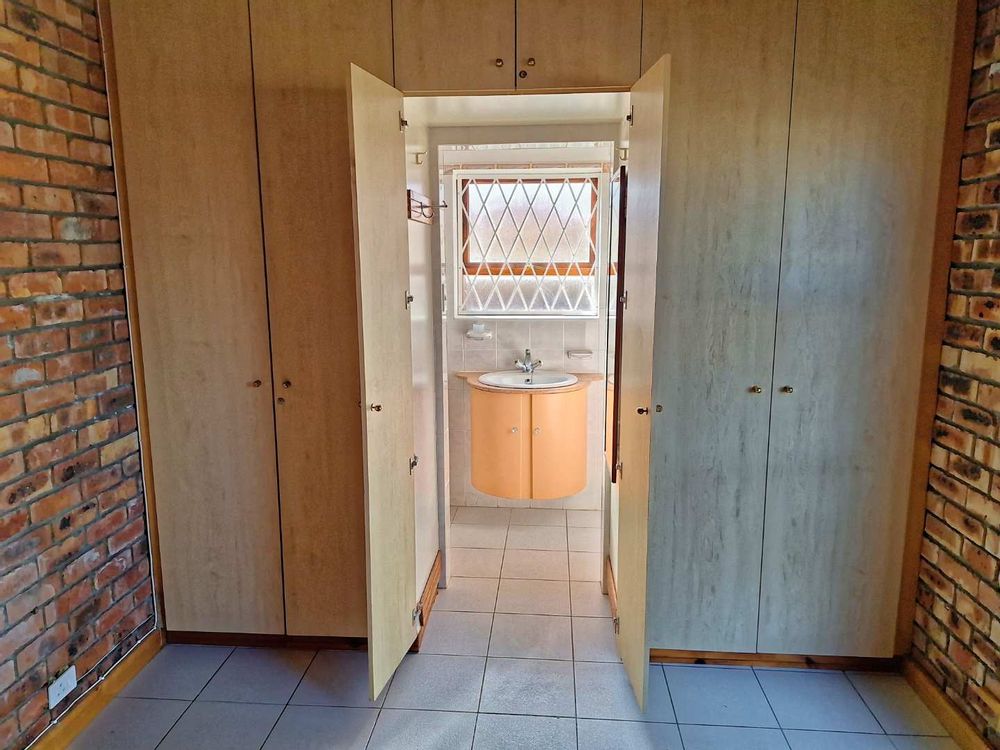 Main bedroom with built-in cupboards and en-suite