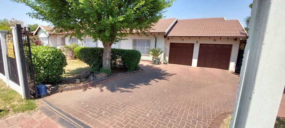 driveway to garage, home and carport on the left