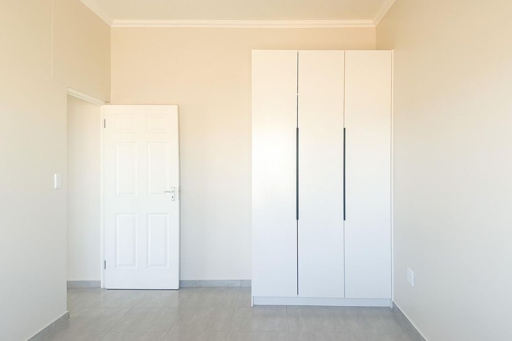 Second bedroom with built-in cupboards.