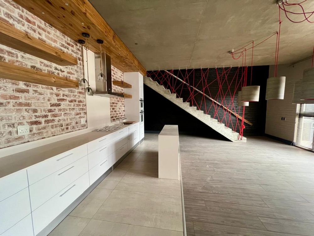 Kitchen, lounge and dining room. Stairs leading to the first floor