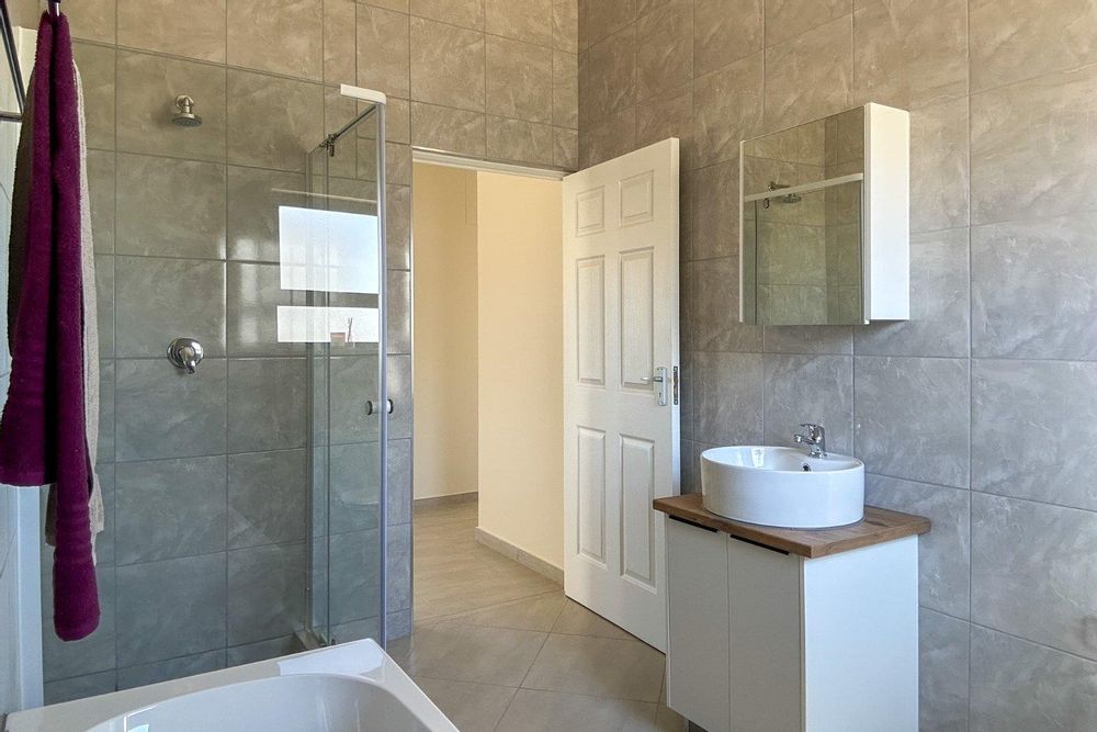 Family bathroom with bath and shower.