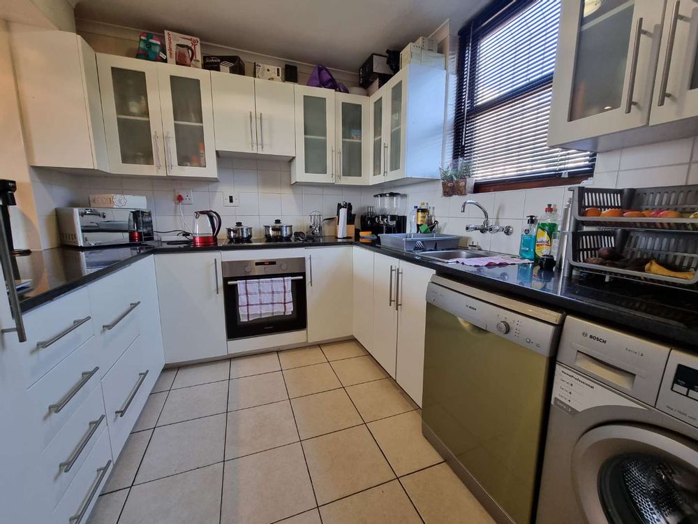 Kitchen with fitted stove, plumbing space for washing machine & dishwasher