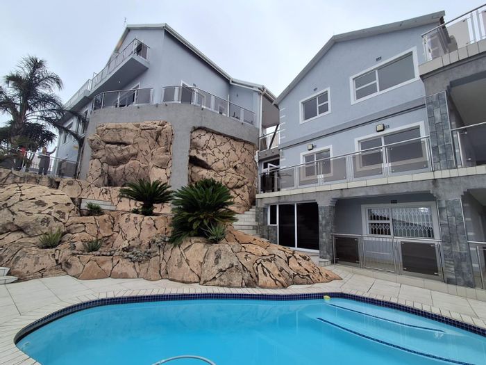 For Sale: Bassonia House with 14 bedrooms, dual pools, and expansive parking.