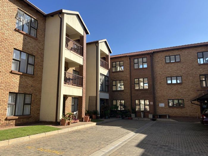 For Sale: Townhouse in Brentwood Park with covered parking, frail care center, and library.