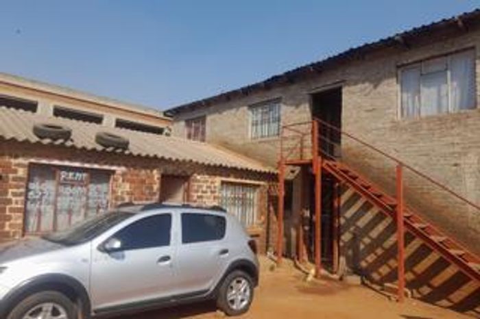 For Sale: House in Tembisa Central with 14 rental rooms, high income potential.