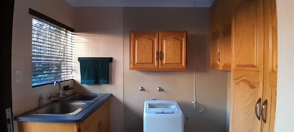 Plenty of cupboards in the washing up area.