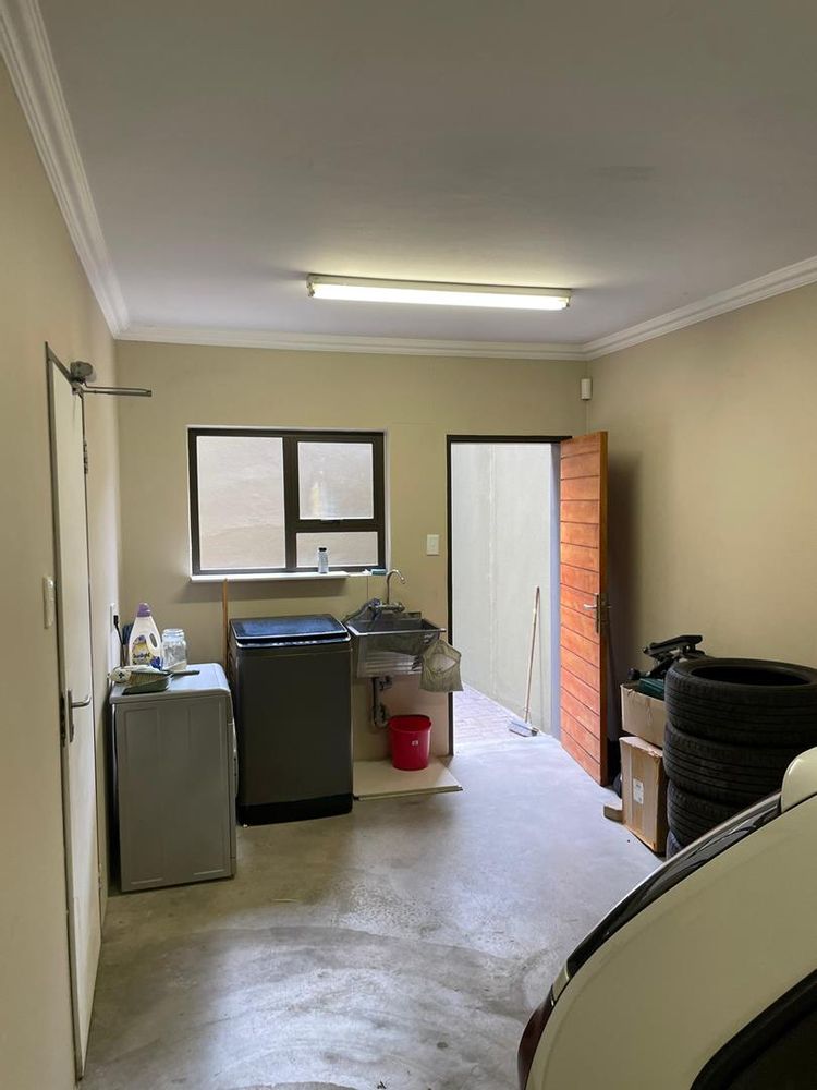 Tandem garage and wash room leading to a courtyard