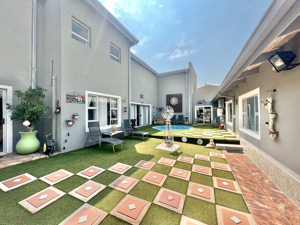 Neat courtyard between house and office building with heated splash pool and detached lapa with built-in-braai.