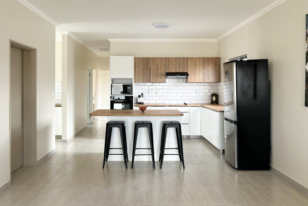 Modern open plan living area with integrated kitchen.