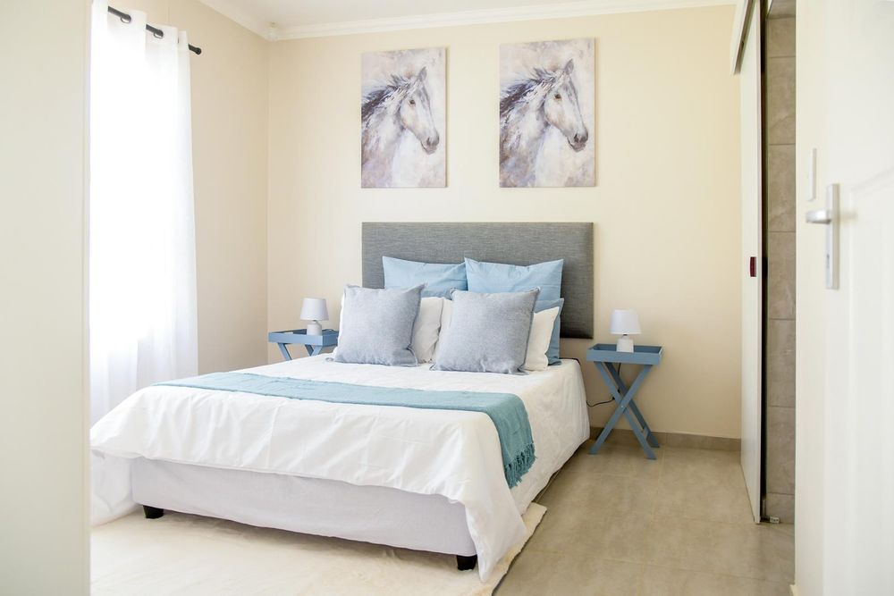 Main bedroom with built-in cupboards and ensuite bathroom.