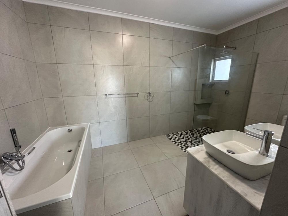 Master bedroom with double sinks, bath and shower.