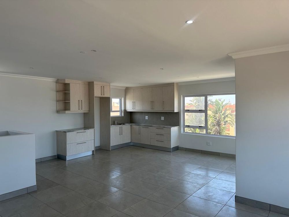 Upstairs living and kitchen area with a sea view and small veranda 