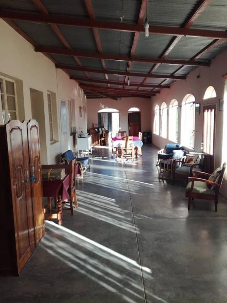 Wide "hallway" used as a lounge/ dining area in the main house