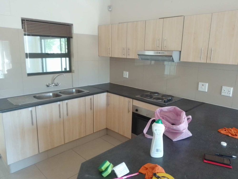 General view of the kitchen with build in cupboards and stove top and oven. 