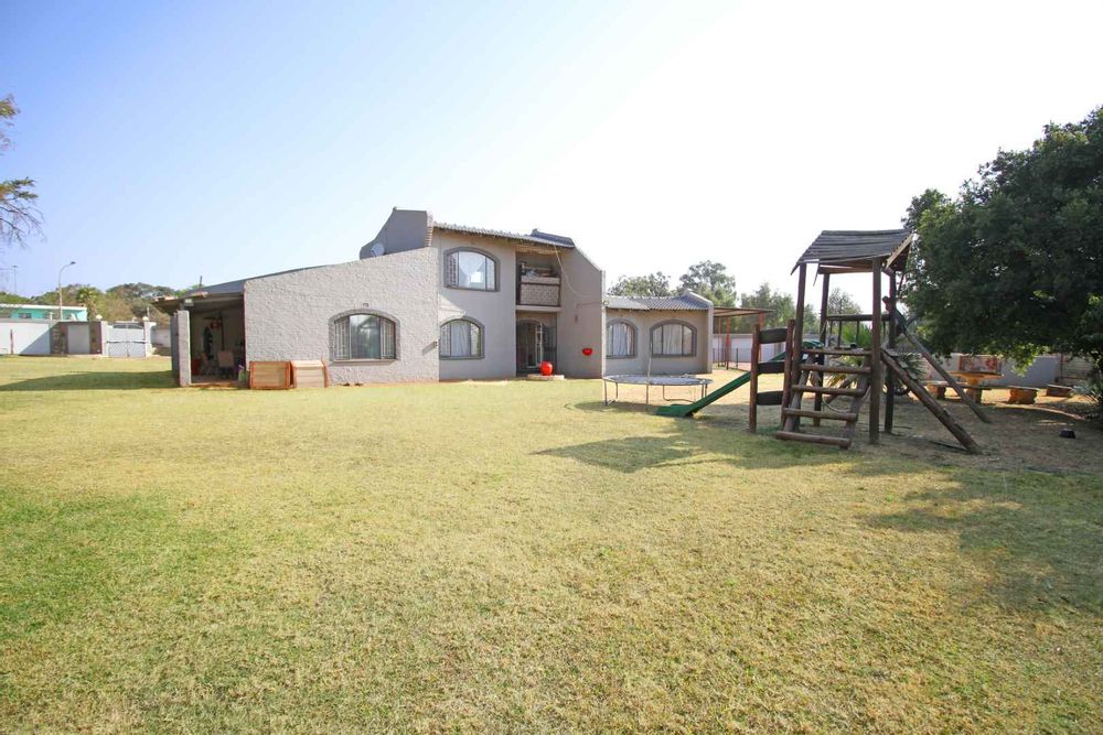 View from the back of the property displaying the expansive 2304m² Erf; The Jungle Gym Kids Play Area; The Balcony of the Upstairs Bedroom; The Patio and the enormous Garden Terrace  