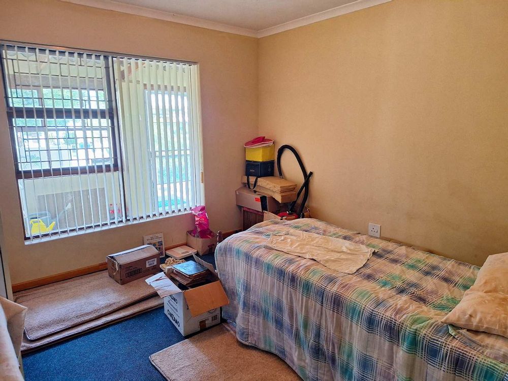 Bedroom 2 in main house with built-in cupboards