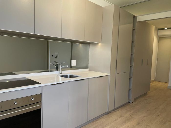 1-Bedroom Apartment To Rent in Rosebank with Skybar, Gym, and Mall Access.