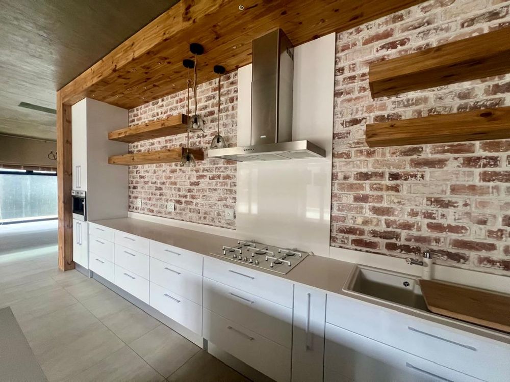 Kitchen with built-in cupboards, oven and coffee machine. The appliances are all SMEG