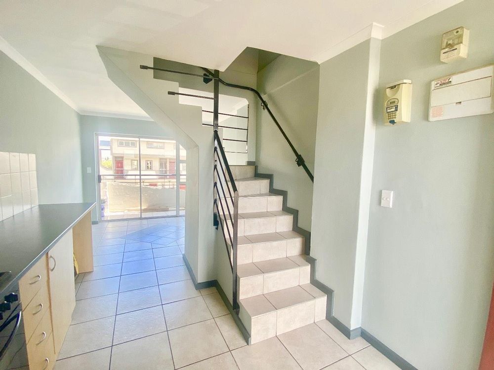 the stairs leading to the bedrooms and the shared bathroom
