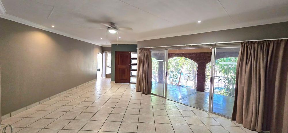 The large living room opens up to the enclosed patio with built-in braai