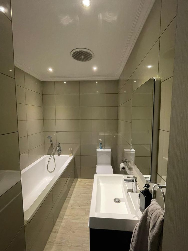 Ensuite bathroom with bath and shower