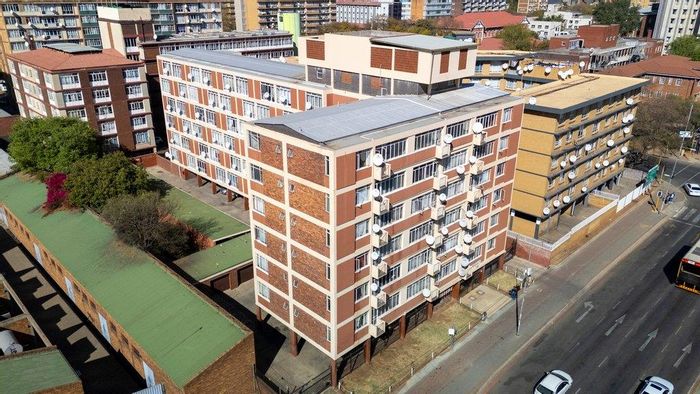 Spacious apartment in Pretoria Central for sale, featuring open-plan living and sunroom.