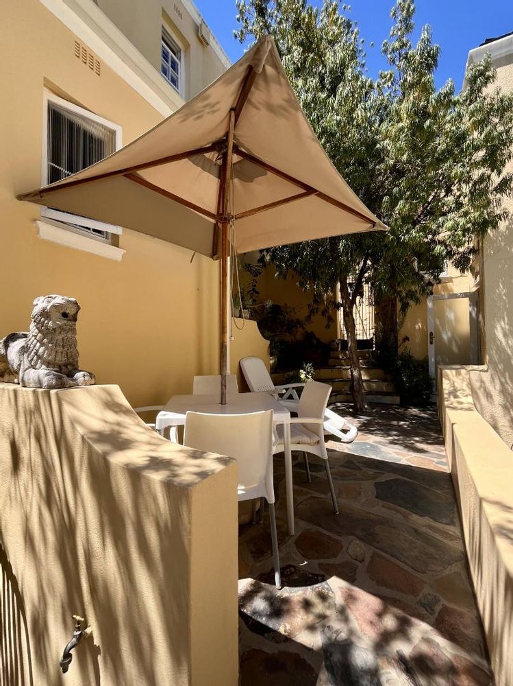 Exclusive-use area with shaded table and umbrella dinning space.