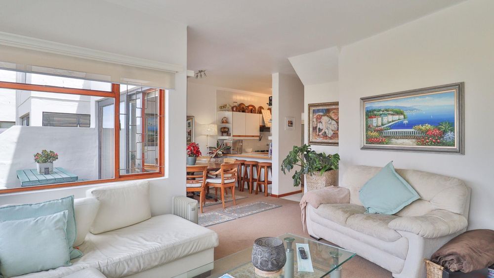 Open plan living and dining room space  with carpet floors