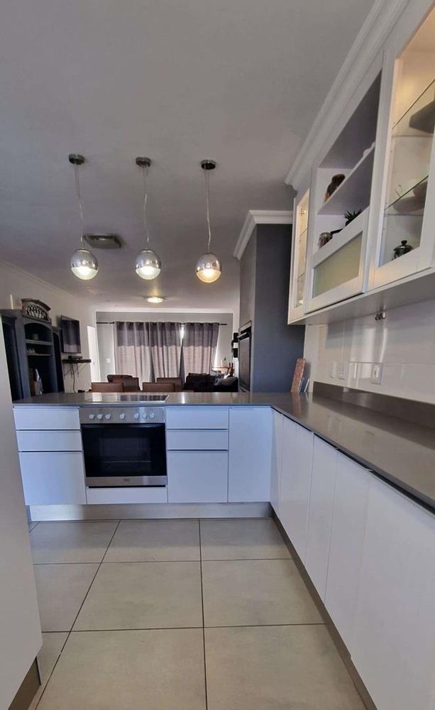 Modern open plan kitchen with beautiful white cupboards