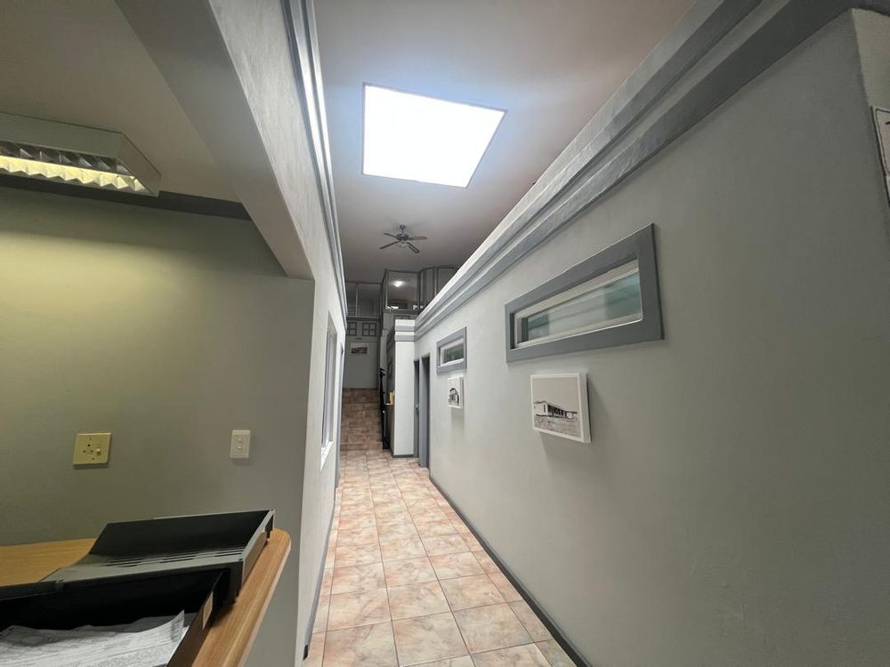 Hallway leading to offices and staircase.