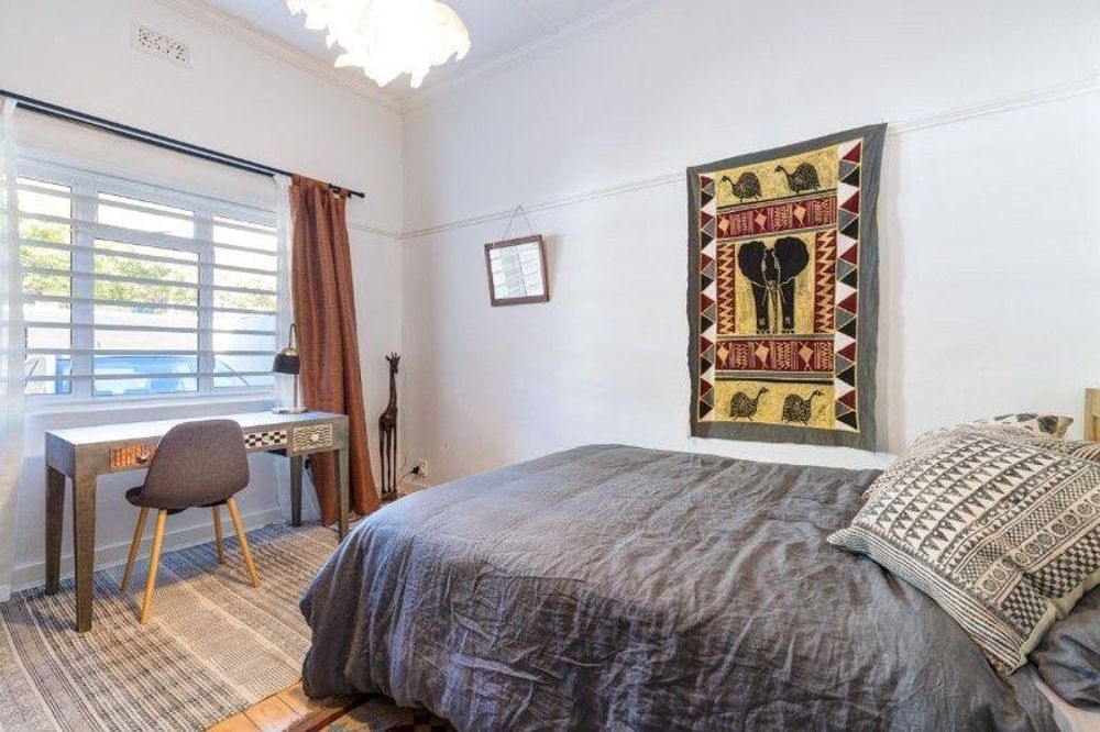 Second bedroom featuring high ceilings and beautiful wooden floors