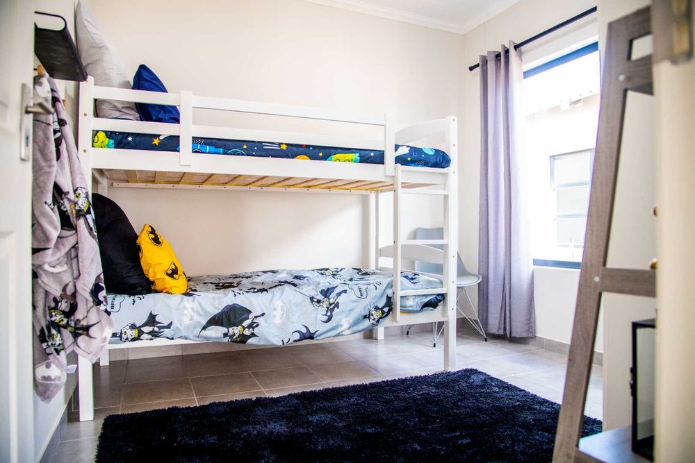 Second bedroom with built-in cupboards.