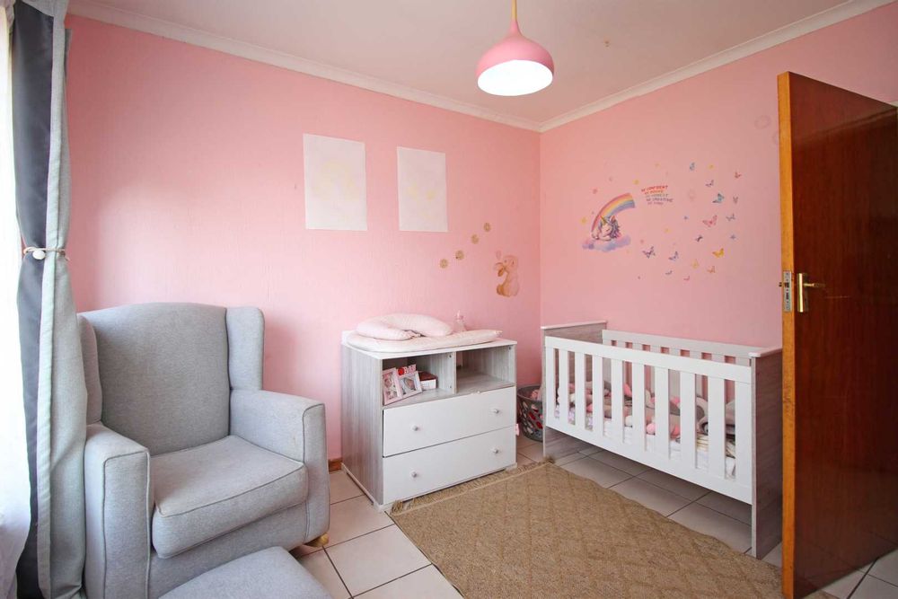 Bedroom 3 : The Nursery with Baby Cot, Baby Compactum Unit and Wing Back Armchair and matching Ottoman, with Built-In Cupboards and Tiled Floors